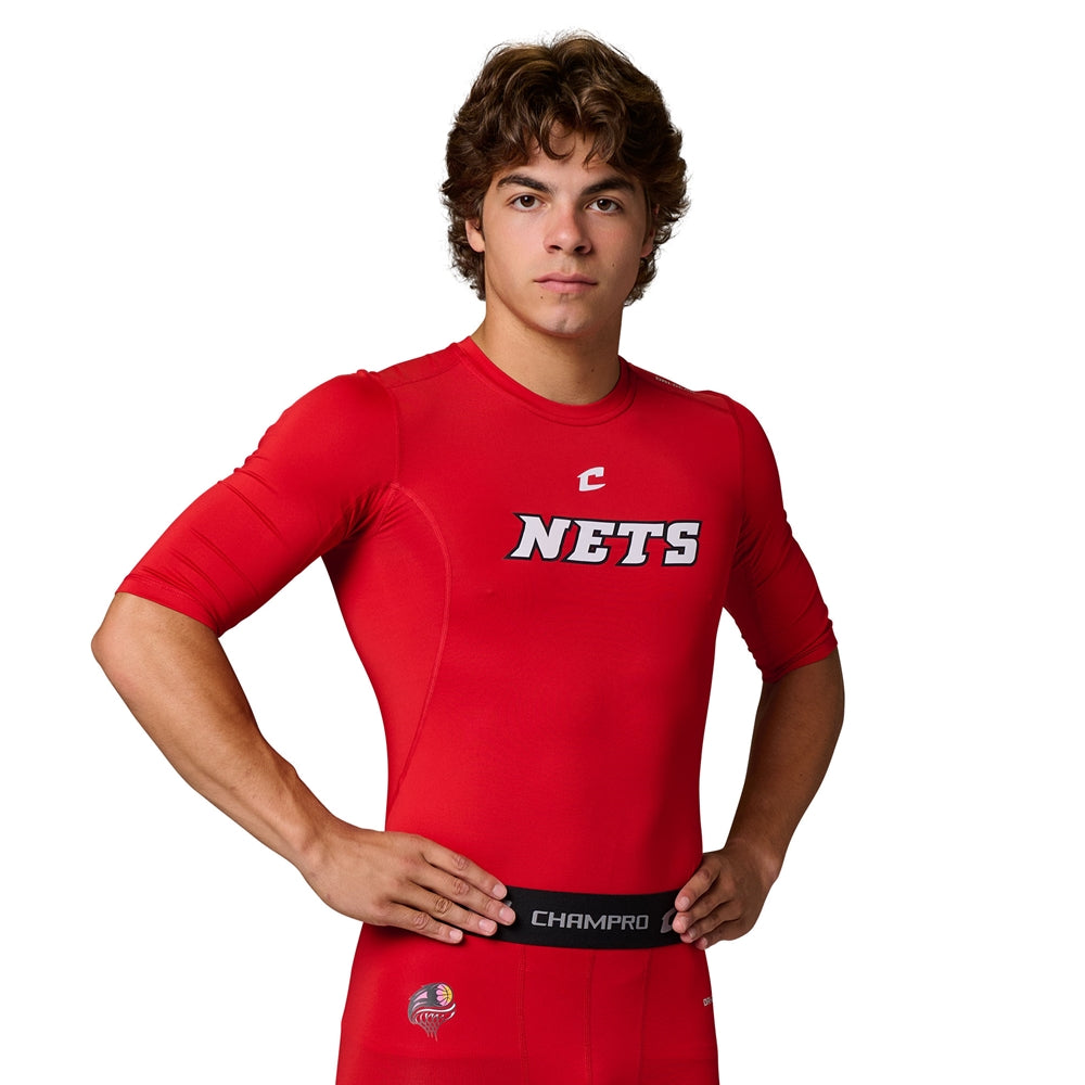 Front view of a male model wearing a red Champro Youth Lightning 2.0 compression half sleeve jersey with a Nets logo on the chest