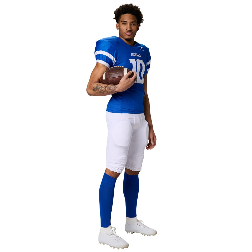 Athlete in a blue Champro Game Day jersey holding a football, wearing white padded football pants and blue socks.