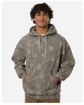 A man wearing a gray camouflage hoodie with a tree branch print, standing against a light gray background.