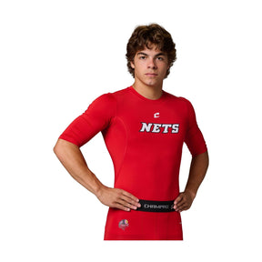 Front view of a male model wearing a red Champro Youth Lightning 2.0 compression half sleeve jersey with a Nets logo on the chest