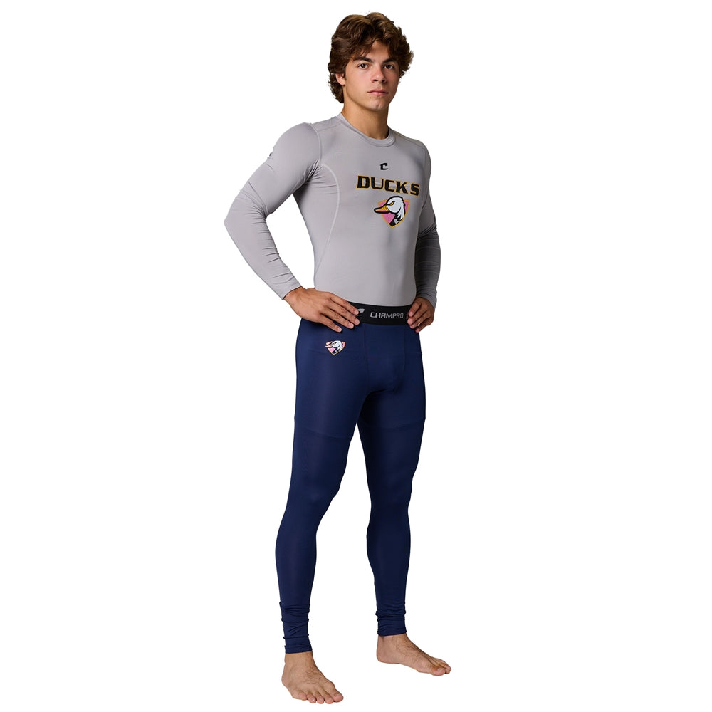 Front view of male model in gray Champro Youth Lightning 2.0 compression long sleeve top and navy full length tights