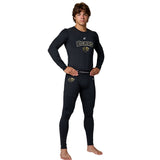 Young male model in black Champro Bears compression top and tights with a belt, facing forward with hands on hips.