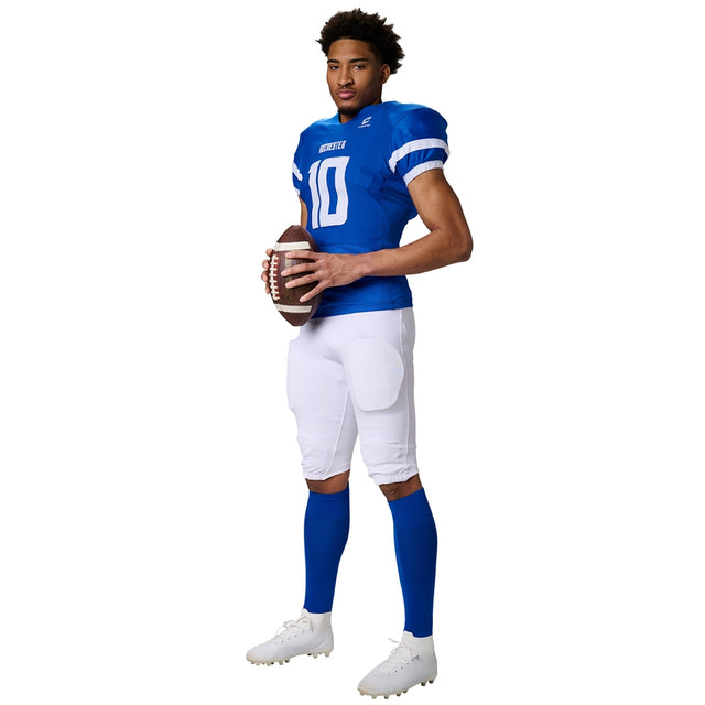 Full-body side view of a football player in a blue Champro Game Day jersey and white padded football pants with blue socks.